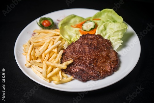 hamburger with french fries isolated on plate.