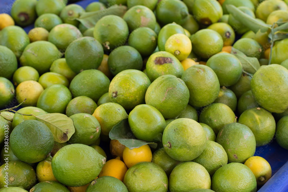 green lemon fresh fruits tropic food concept background on market counter
