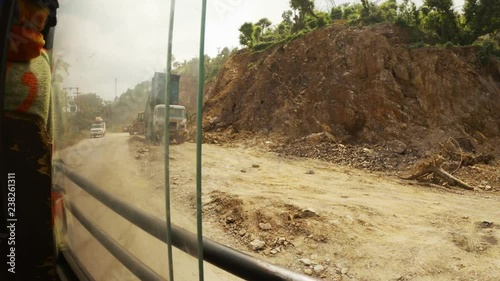 Landslide work on high mountains of Himalaya workers machinery tractor view from moving bus