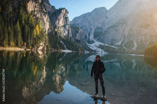 Man Standing on Rock at Beautiful Alpine Lake © andrii_popovych