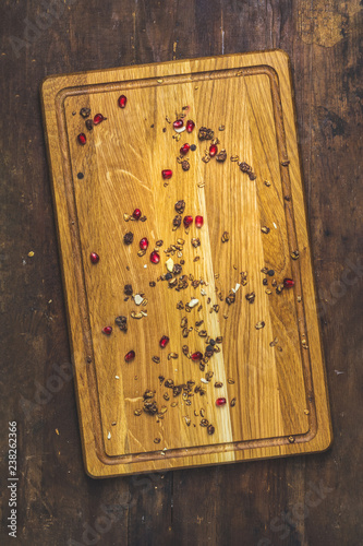 Cutting board with granola and pomegranate berries