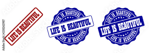 LIFE IS BEAUTIFUL scratched stamp seals in red and blue colors. Vector LIFE IS BEAUTIFUL labels with distress texture. Graphic elements are rounded rectangles, rosettes, circles and text labels.
