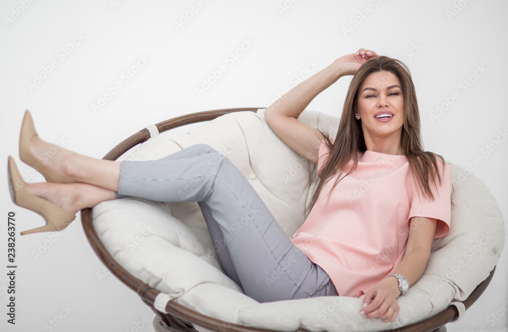 beautiful young woman sitting in comfortable chair. beautiful young woman sitting in comfortable chair.