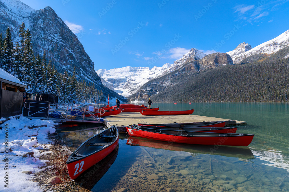Red canoes at Lake Louise with rocky mountain in Banff national park