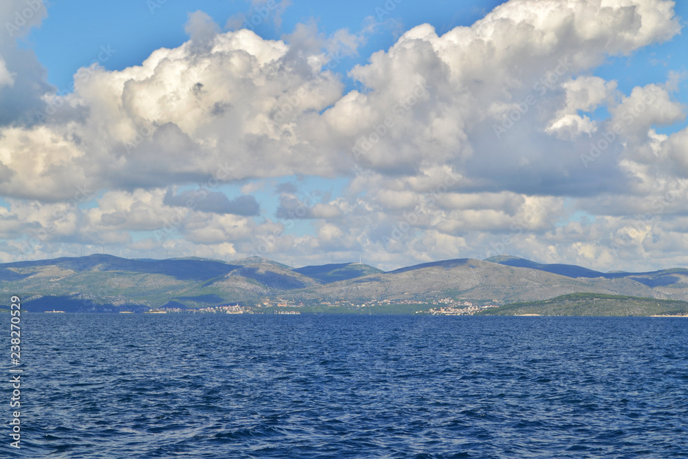 Adriatic sea in Croatia, land in the distance. The blue sky and white clouds.