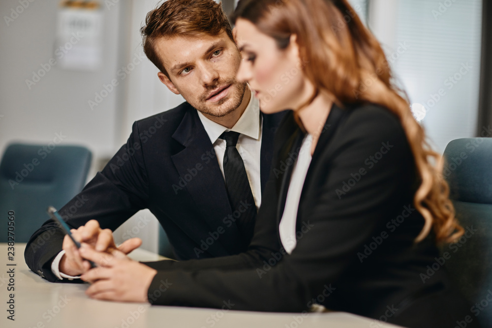 A couple of bussinessmen and bussines woman discussing an important topic A couple of bussinessmen and bussines woman discussing an important topic
