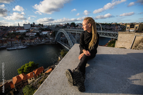 Woman with dreadlocks on the viewing platform opposite the Dom Luis I bridge, Douro river, Porto, Portugal. © De Visu