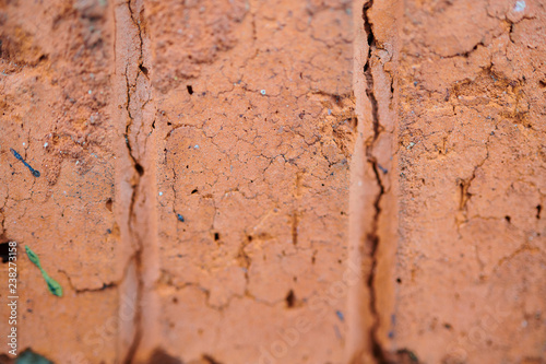 The texture of old red bricks with fissures and fractures, background