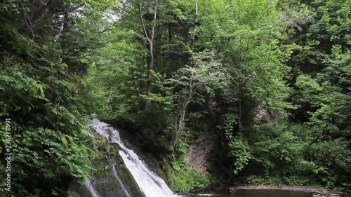 Little noisy waterfall among the silent woods.Nature concept. No people around