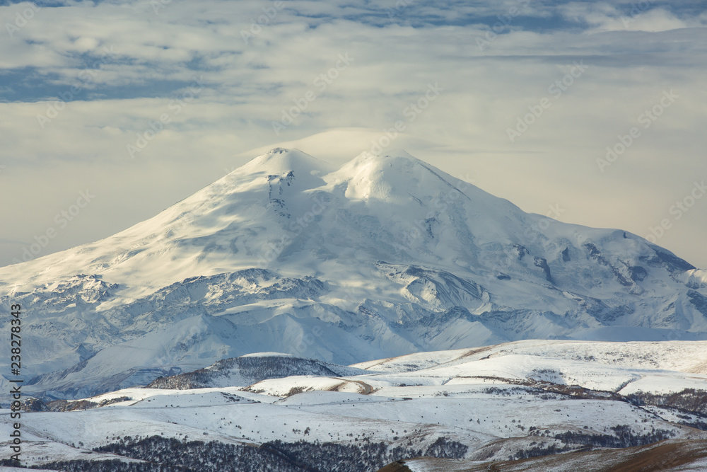 Russia, the Caucasus Mountains, Kabardino-Balkaria. Mount Elbrus in the autumn sun at daybreak. Russia, the Caucasus Mountains, Kabardino-Balkaria. Mount Elbrus in the autumn sun at daybreak.