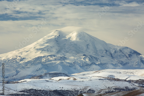 Russia, the Caucasus Mountains, Kabardino-Balkaria. Mount Elbrus in the autumn sun at daybreak.