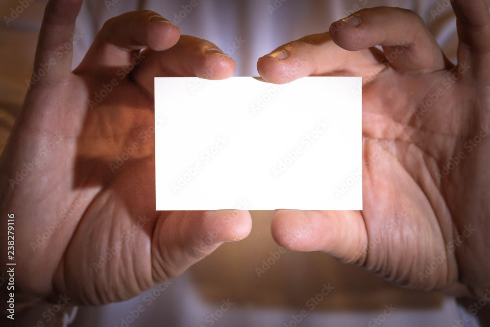 Two hands holding a blank business card. Two hands holding a blank business card.