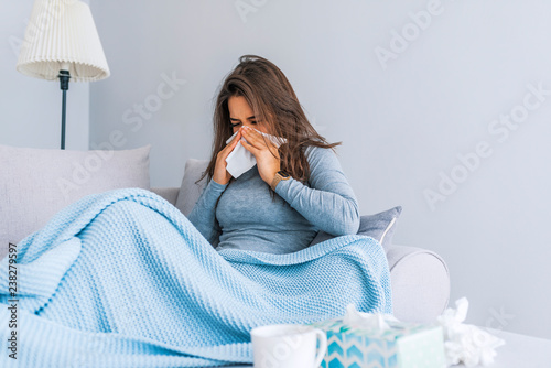 Sick Woman.Flu.Woman Caught Cold. Sneezing into Tissue. Headache. Virus .Medicines photo
