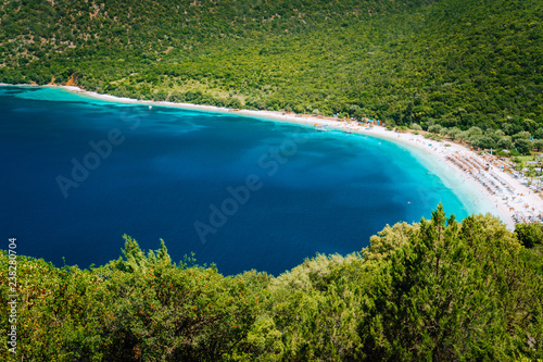 Sunny summer day on Antisamos beach on Kefalonia island  Greece. Crystal clear water  huge hills beautiful white beach  picturesque nature. Stunning view of mediterranean coastline