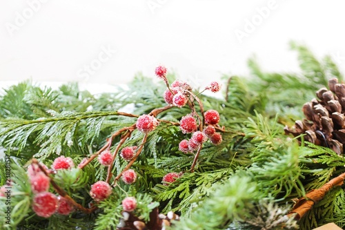 christmas holiday background with real fresh fir leaves on white frame with copy space