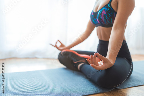 Yoga meditation at home. Relax concept with unrecognizable spiritual young woman