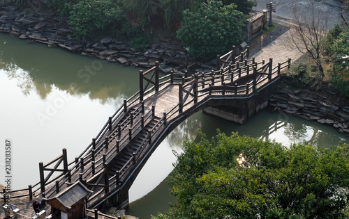 View from the top of  fortress. Chinese bridge on a calm canal. At Chibi city.