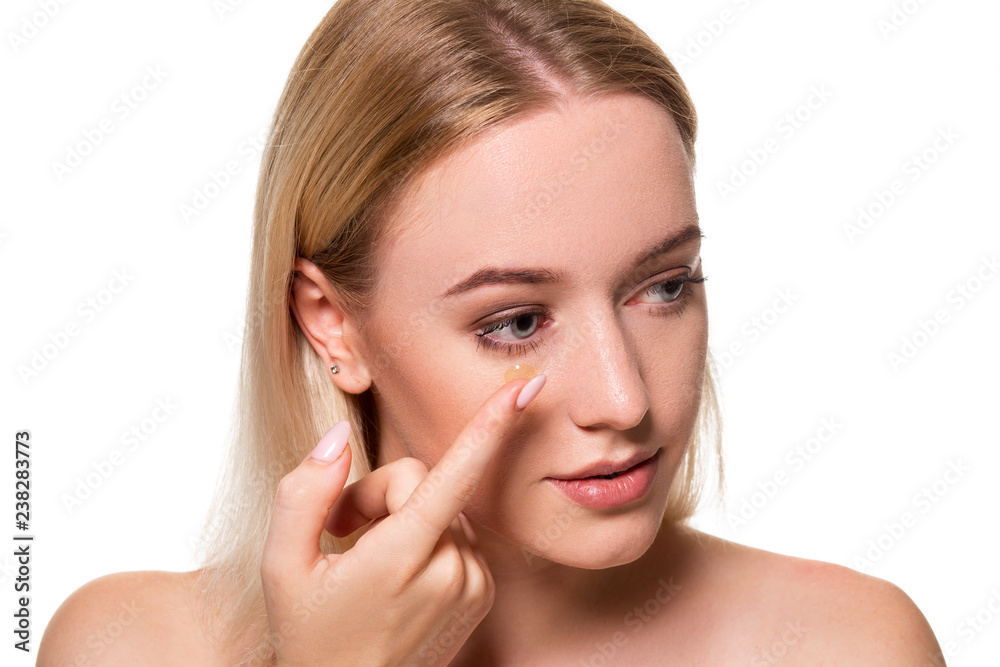Young woman holding contact lens on index finger with copy space. Close up face of healthy beautiful woman about to wear contact lens. Young woman holding contact lens on index finger with copy space. Close up face of healthy beautiful woman about to wear contact lens.
