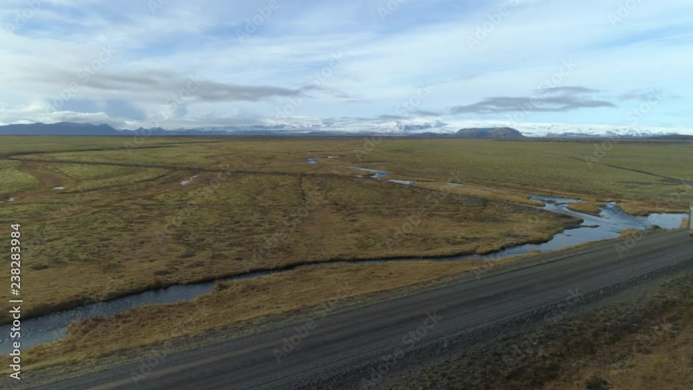 Cargo livestock truck on dirt road under Vatnajokull glacier Iceland, aerial.mov