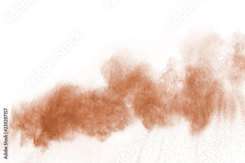 Brown color powder explosion on white background. Colored cloud. Colorful dust explode. Paint Holi.