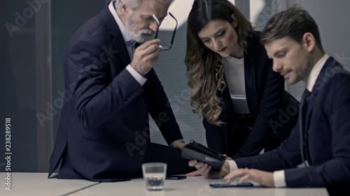 A couple of bussinessmen and bussines woman discussing an important topic