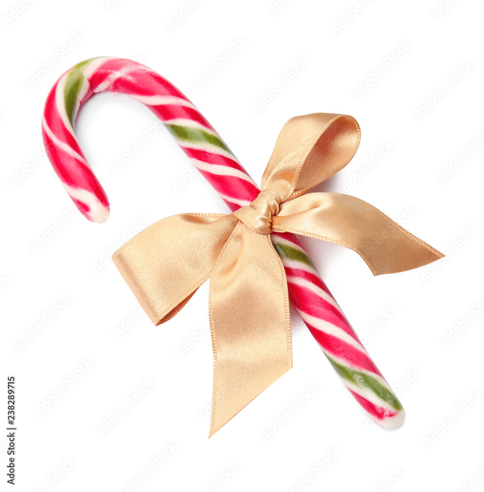 Tasty candy cane with bow on white background. Festive treat Tasty candy cane with bow on white background. Festive treat