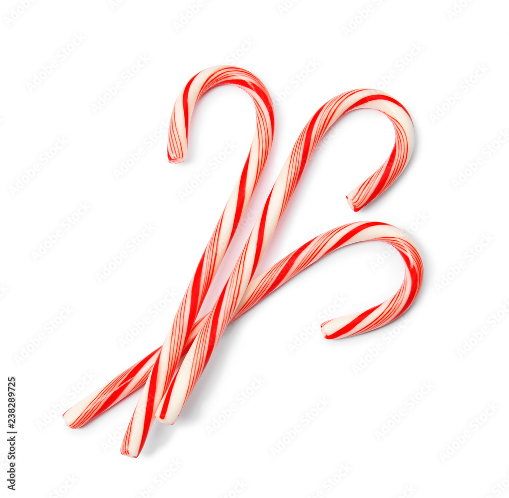 Tasty candy canes on white background. Festive treat