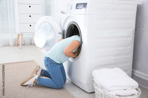 Adorable little girl having fun at home on laundry day