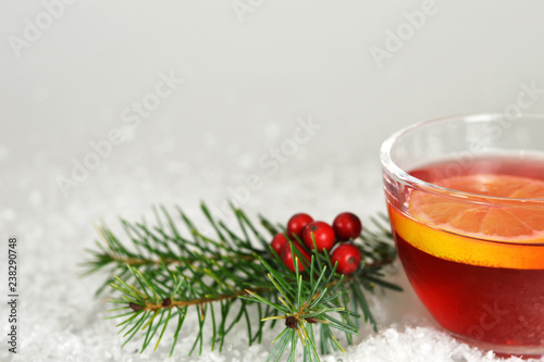 Christmas tea with lemon slice in transparent cup