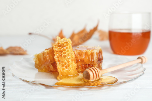 Plate with honeycomb pieces and dipper on table