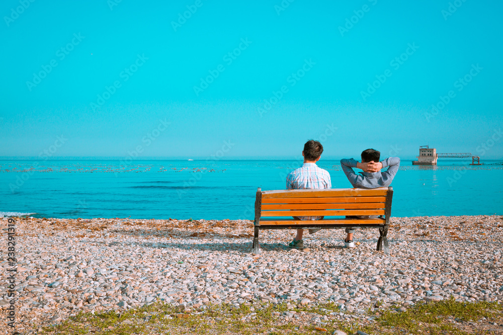 Dalian Lushun, Dalian Medical University, man, sea, blue, tourism, beach Man sitting in a chair watching the sea