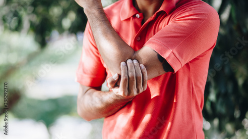 Man suffering from pain in hand or elbow , health care concept