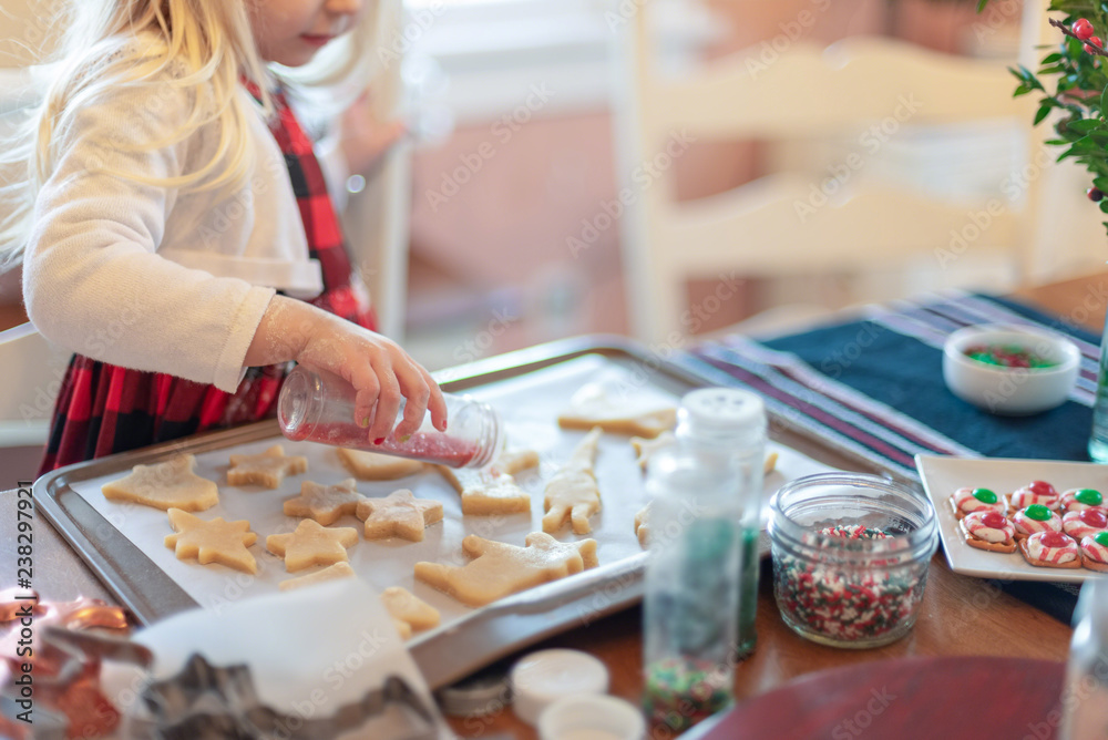 Little girl decorating sugar cookies for Christmas Little girl decorating sugar cookies for Christmas