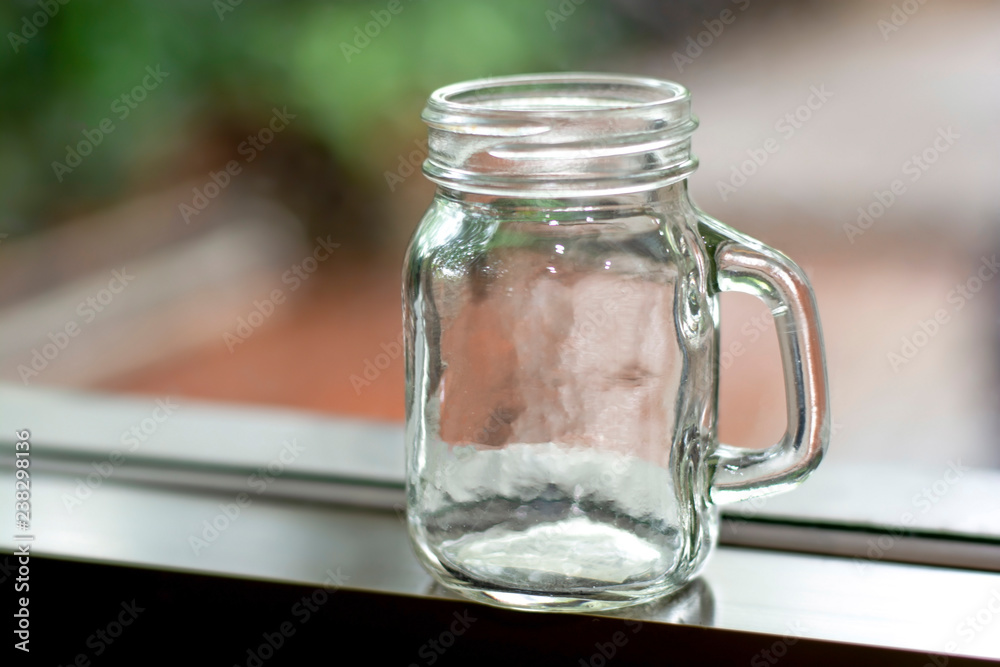 Empty glass jug on background blurred, Clear bottle, Beer mug. Empty glass jug on background blurred, Clear bottle, Beer mug.