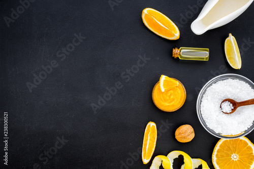 homemade spa with citrus cosmetic oil on black background top view mock-up