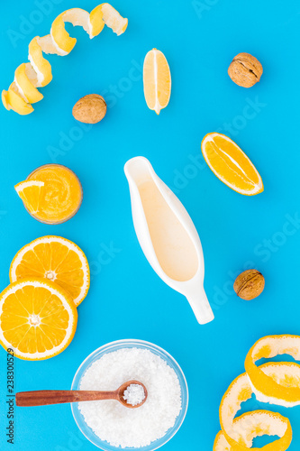 organic cosmetics for homemade spa with orange oil blue background top view pattern