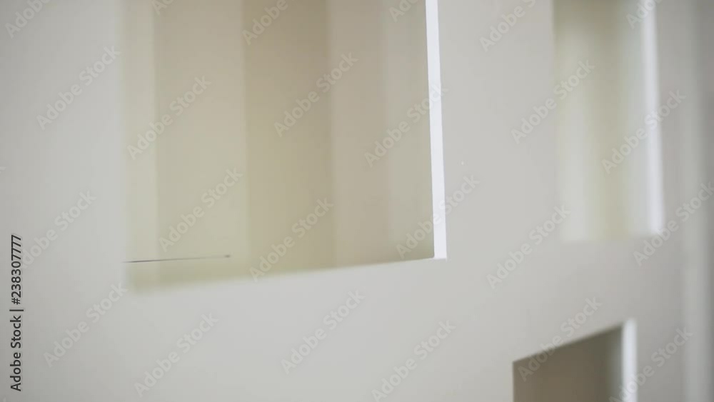 Camera is showing cute white plastic frames of windows and doors in daylight empty room. Camera is showing cute white plastic frames of windows and doors in daylight empty room.