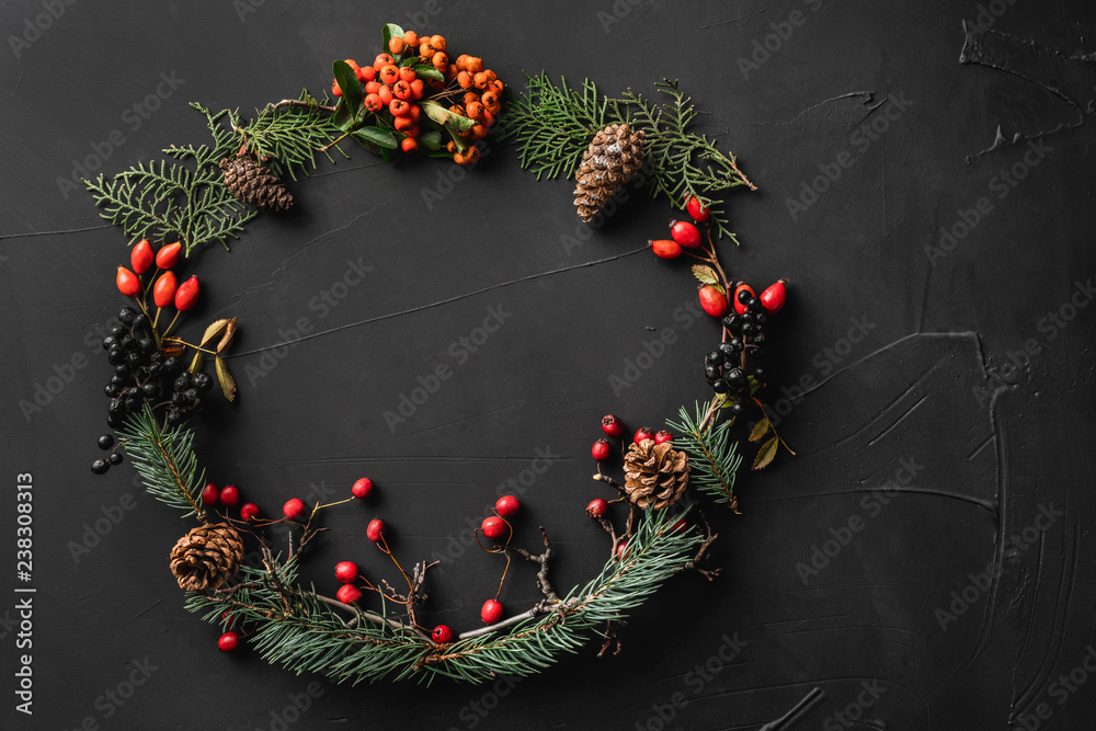 custom made wallpaper toronto digitalCrown of Christmas tree branches, pine cones, berries, nuts, on black stone background. Xmas and Happy New Year theme. Flat lay, top view