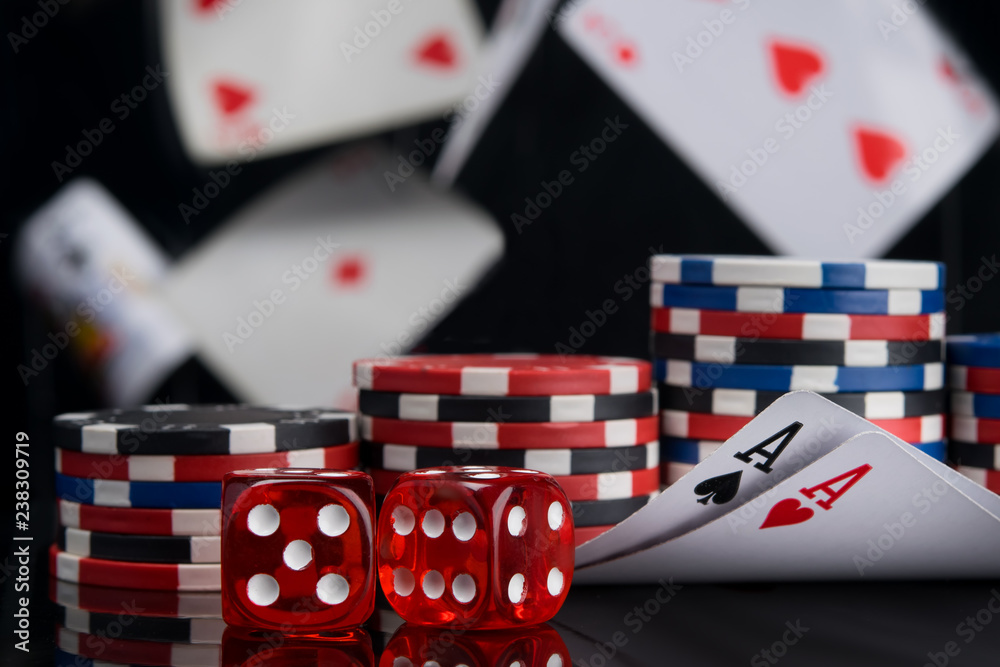 Obraz premium set for playing for money, two aces and dice on a black background, flying cards