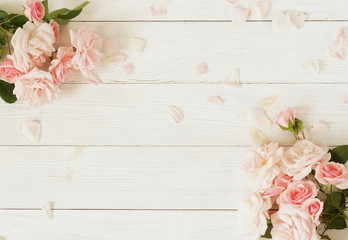 Flowers background. Bouquet of beautiful pink roses on white wooden background.Top view.Copy space