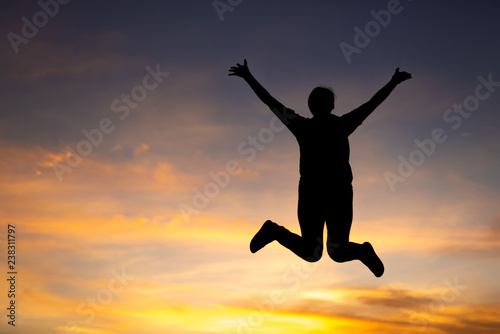 Wallpaper Mural happiness, freedom, motion and people concept - smiling young woman jumping in air sunset background Torontodigital.ca