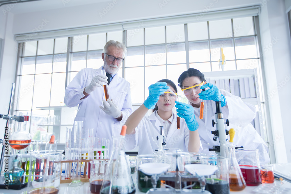Medical Research and Scientists are working with a microscope and a tablet and Test Tubes, Micropipette and Analysis Results in a laboratory. Medical Research and Scientists are working with a microscope and a tablet and Test Tubes, Micropipette and Analysis Results in a laboratory.