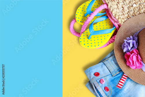 Beach accessories on yellow and blue color background, flat lay photo