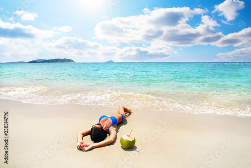 Fototapeta Naklejka Na Ścianę i Meble -  Beautiful girl with coconut on beach