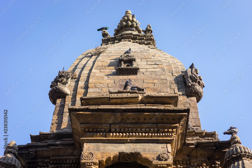 Roof of ancient Hindu temple in Nepal with pigeons