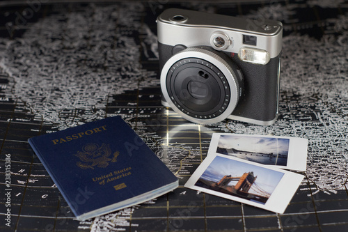 Getting ready to travel the world with passport and camera on a map