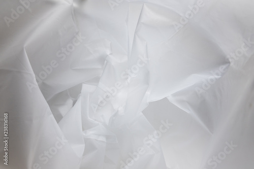 Abstract texture of a crumpled ethylene-vinyl acetate  EVA  material. Gray chaotic lines  folds and patterns on the synthetic surface.