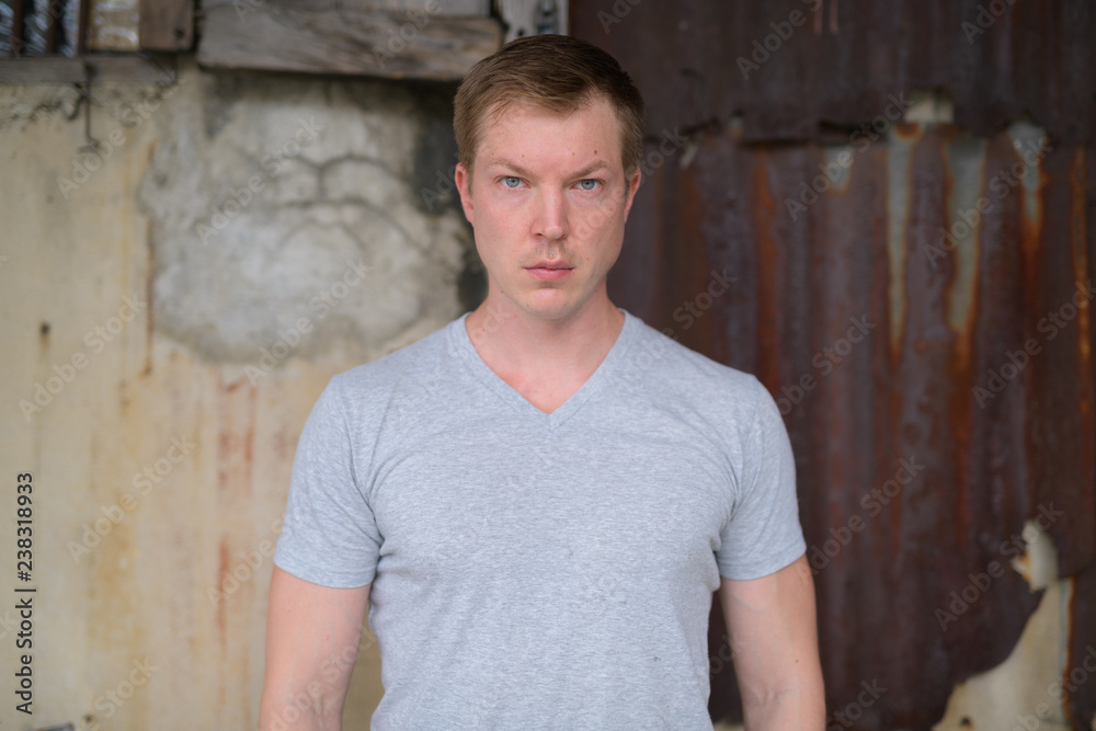 Young handsome tourist man against grungy wall Young handsome tourist man against grungy wall