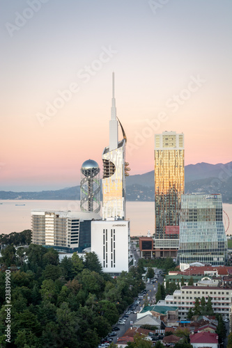 Batumi, Adjara, Georgia - October 2018: Panoramic view of Batumi sea resort from the Sheraton hotel at the sunset with skyscrapers and mountains in background