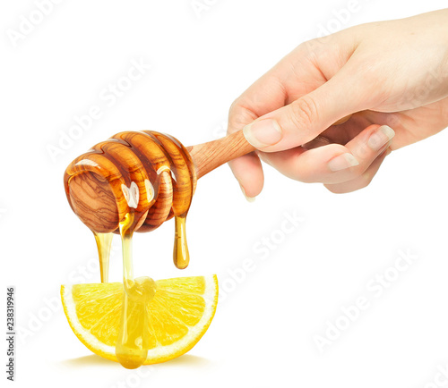 Woman holding dipper with honey dripping and lemon isolated on white